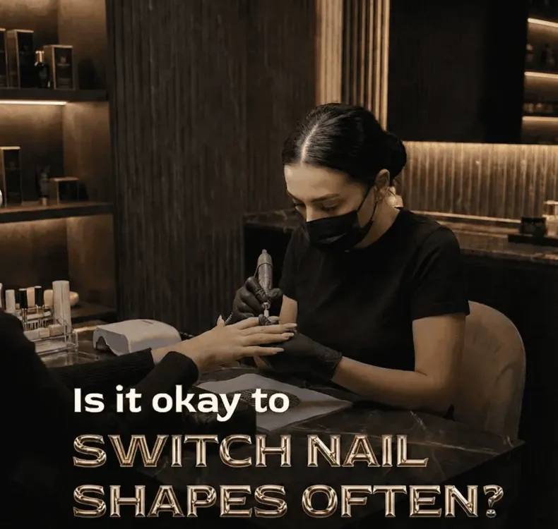 Nail technician shaping a client's nails, wearing a mask and gloves.